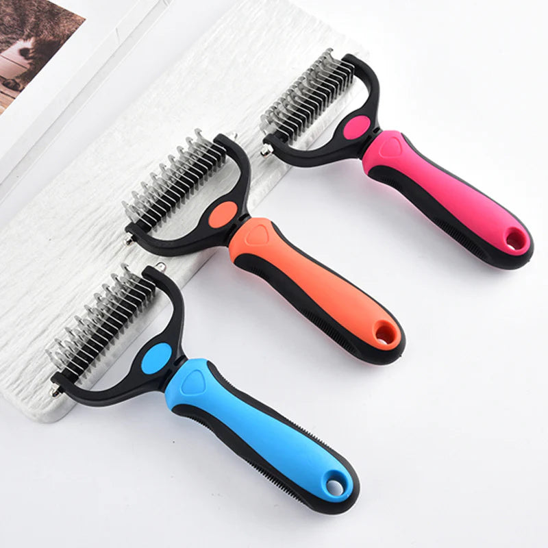 Three pet grooming tools with different colored handles on a white background