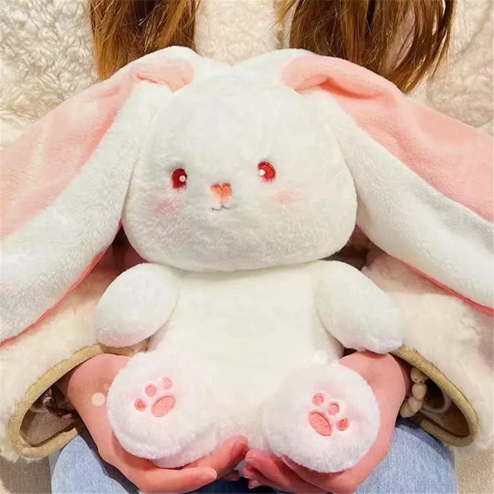 Person holding a plush bunny toy with large ears and soft texture