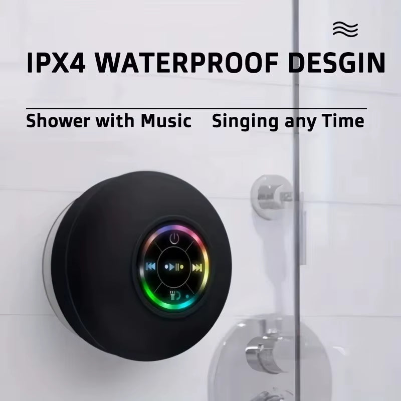 Black shower speaker with colorful display on a tiled shower wall, featuring IPX4 waterproof design text.