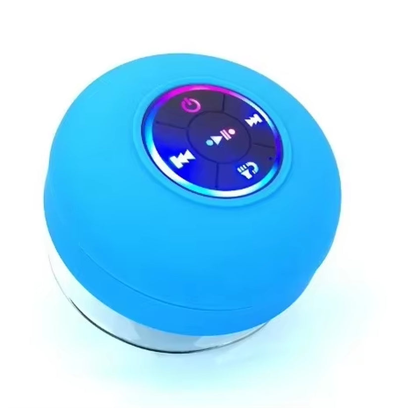 Blue round Bluetooth speaker with control buttons on a white background